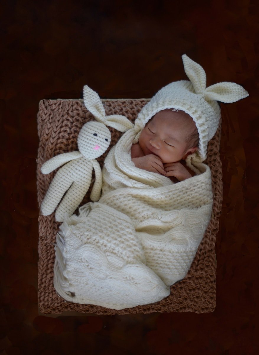 baby wearing white sleeper